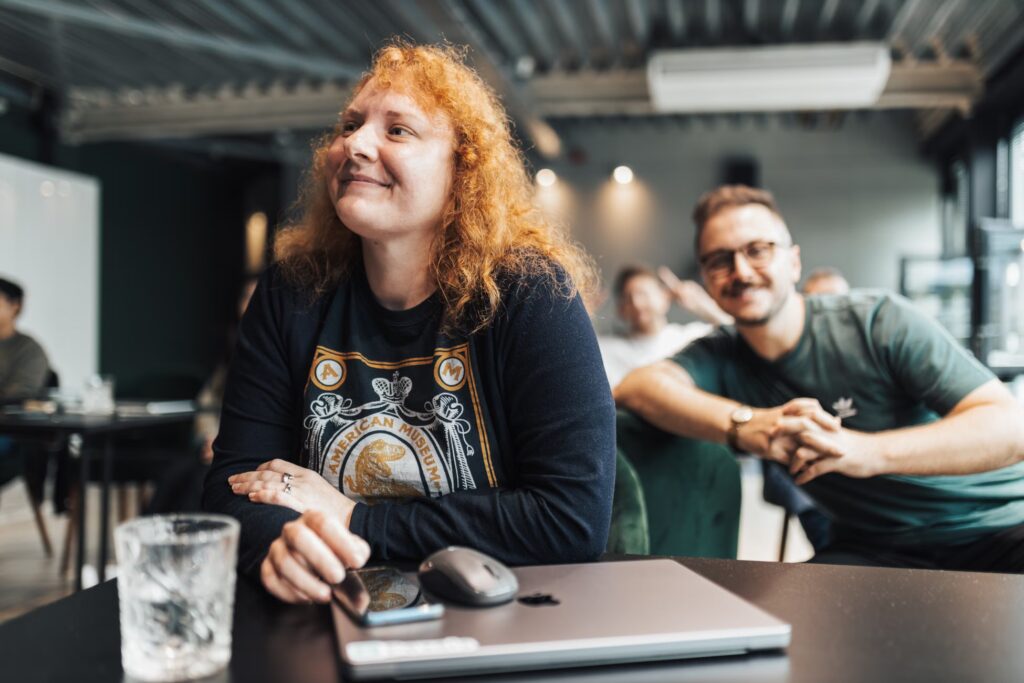 Colleagues enjoying a casual meeting in a modern office setting.